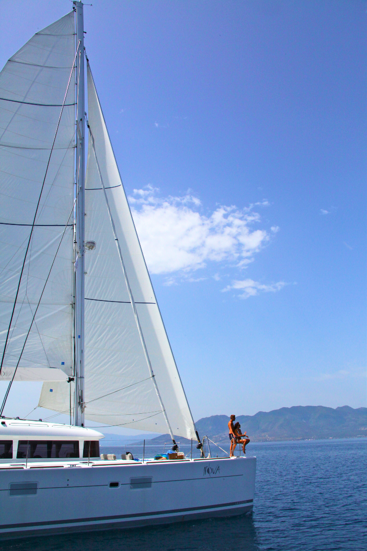 two-people-in-front-of-yacht-at-sea