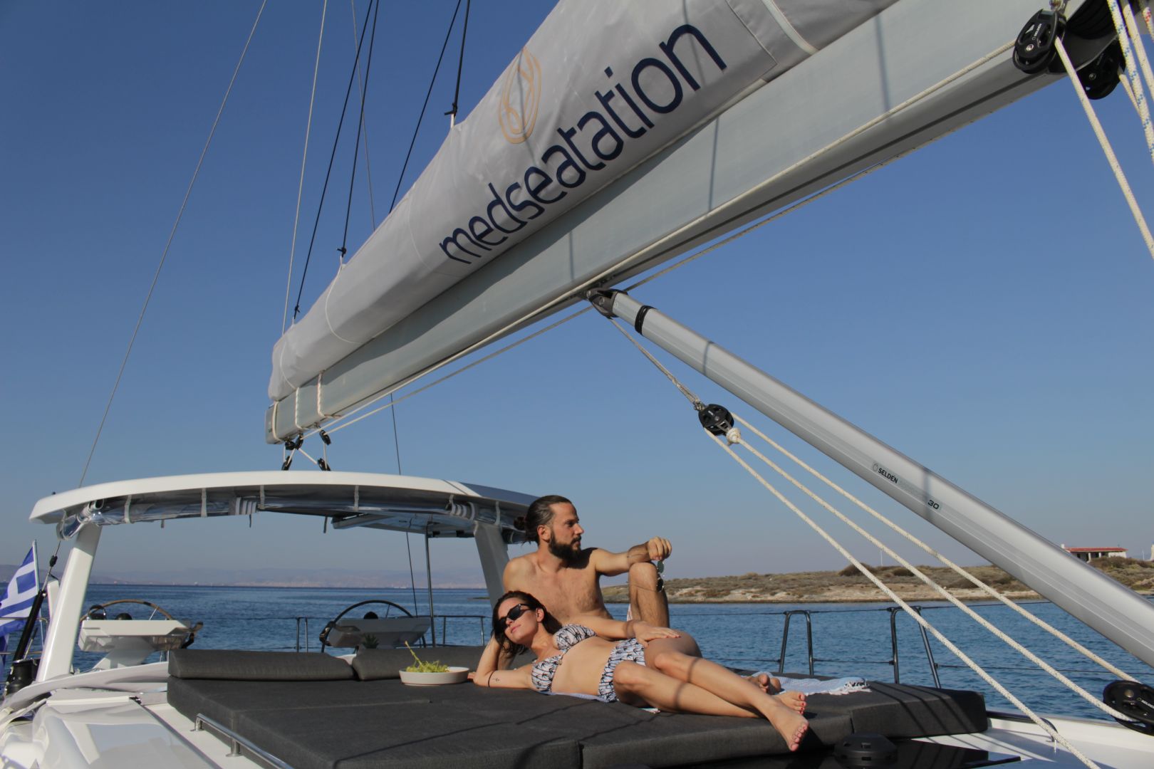 couple-sunbathing-on-deck