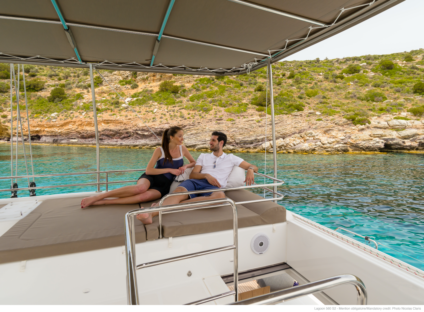 catamaran-couple-laying-on-deck