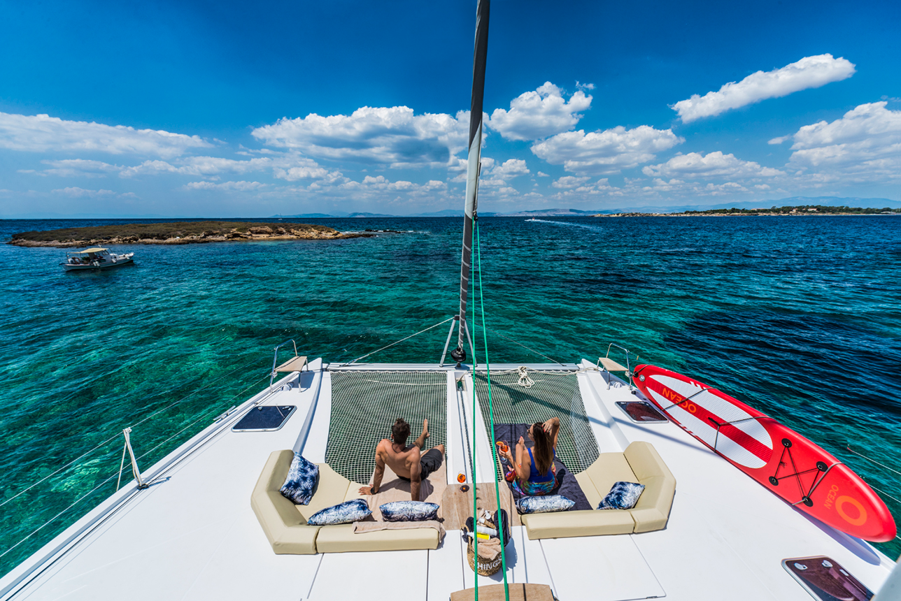 catamaran-on-bow-couple-sunbathing