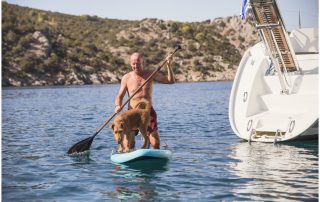 man-with-dog-paddling-at-sea